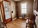 Inviting foyer with hardwood floors, wooden bench, coat rack, and natural light at 303 S Walnut St, Edinburgh, IN 46124