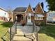 Charming brick home with landscaped front yard, walkway and peaked roofline at 303 S Walnut St, Edinburgh, IN 46124