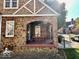 Charming brick home with a covered front porch and well-manicured lawn at 303 S Walnut St, Edinburgh, IN 46124