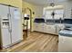 Classic kitchen with white cabinets, matching appliances, and hardwood floors at 303 S Walnut St, Edinburgh, IN 46124