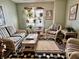 Comfortable sitting room featuring wicker furniture, striped cushions, and indoor plants at 303 S Walnut St, Edinburgh, IN 46124