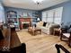 Cozy living room with fireplace, built-in bookshelves, hardwood floors, and natural light at 303 S Walnut St, Edinburgh, IN 46124