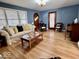 Bright living room featuring hardwood floors, a comfortable sofa, and natural light from large windows at 303 S Walnut St, Edinburgh, IN 46124