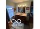 Classic bathroom with dark wooden vanity, tile floor, white curtain, and decorative lighting at 3030 N 600 E, Lebanon, IN 46052