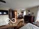 Large bedroom with gleaming hardwood floors, ceiling fan, and additional seating area at 3030 N 600 E, Lebanon, IN 46052