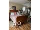 Inviting bedroom with hardwood floors, sleigh bed, and decorative shelving unit at 3030 N 600 E, Lebanon, IN 46052