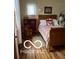 Cozy bedroom with hardwood floors, sleigh bed, and sunny window with sheer curtains at 3030 N 600 E, Lebanon, IN 46052