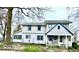 Two-story home boasts a welcoming front porch, well-maintained lawn, and mature trees at 3030 N 600 E, Lebanon, IN 46052