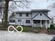 Charming two-story home with inviting front porch and mature trees at 3030 N 600 E, Lebanon, IN 46052