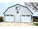 Spacious two-car garage with white doors and blue trim, offering ample storage and parking at 3030 N 600 E, Lebanon, IN 46052