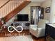 Open floor plan showcases the staircase, a cozy chair, and a vintage media center at 3030 N 600 E, Lebanon, IN 46052