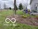 Well-maintained yard featuring artful landscaping and garden beds near the back of the home at 3030 N 600 E, Lebanon, IN 46052