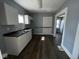 Functional kitchen featuring white cabinets, dark countertops, and wood floors at 3046 Central Ave, Indianapolis, IN 46205