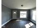 Bright living room featuring new flooring, large windows, and white trim at 3046 Central Ave, Indianapolis, IN 46205