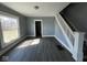 Living area showing staircase and new floors at 3046 Central Ave, Indianapolis, IN 46205