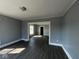 Open-concept living area with new flooring, a large window, and neutral walls at 3046 Central Ave, Indianapolis, IN 46205