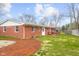 Spacious brick home with a well-maintained lawn, mulch bed, and a charming red deck at 3104 S Pisgah Way, Columbus, IN 47203