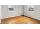 Bright bedroom with hardwood floors, two windows, and neutral paint at 3104 S Pisgah Way, Columbus, IN 47203