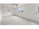 Bedroom features plush carpet, neutral paint, ceiling fan, and access to back yard at 3104 S Pisgah Way, Columbus, IN 47203