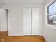 Bedroom with hardwood floors, closet, window, and neutral paint at 3104 S Pisgah Way, Columbus, IN 47203