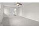 Bright, carpeted bedroom with ceiling fan and white trim leading to the kitchen at 3104 S Pisgah Way, Columbus, IN 47203
