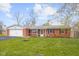Charming brick ranch with a well-manicured lawn, attached garage and front door decorations at 3104 S Pisgah Way, Columbus, IN 47203