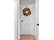 Hallway with wood floors featuring a white door adorned with a decorative wreath at 3104 S Pisgah Way, Columbus, IN 47203