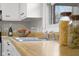 Close up shot of stainless steel kitchen sink, wood counters, and white cabinets at 3104 S Pisgah Way, Columbus, IN 47203