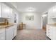 Kitchen area features wood countertops, white cabinets, and neutral colored floor at 3104 S Pisgah Way, Columbus, IN 47203