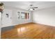 Open living room with large front window, hardwood floors, neutral paint and decor at 3104 S Pisgah Way, Columbus, IN 47203