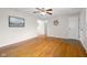 Bright living room with hardwood floors, ceiling fan, neutral paint and entry to other rooms at 3104 S Pisgah Way, Columbus, IN 47203