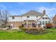 This home's backyard offers a deck, patio, and lush green spaces for outdoor enjoyment at 325 W Greyhound Pass, Carmel, IN 46032