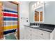 Bathroom with modern vanity, granite counters, and colorful shower curtain at 325 W Greyhound Pass, Carmel, IN 46032