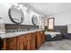 Elegant bathroom with double vanity, granite countertops, and tiled bathtub at 325 W Greyhound Pass, Carmel, IN 46032