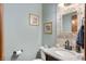 Stylish powder room featuring a granite countertop, decorative mirror, and neutral color palette at 325 W Greyhound Pass, Carmel, IN 46032