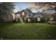 Inviting two-story home with brick and siding facade and a spacious green front lawn at 325 W Greyhound Pass, Carmel, IN 46032