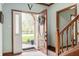 Inviting foyer with an open door, hardwood floors, and a view of the blooming front yard at 325 W Greyhound Pass, Carmel, IN 46032