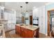 Spacious kitchen featuring custom cabinets, granite island, and stainless steel appliances at 325 W Greyhound Pass, Carmel, IN 46032