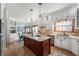 Open kitchen with island, stainless steel appliances, and a view into the adjacent dining area at 325 W Greyhound Pass, Carmel, IN 46032