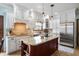Bright kitchen with white cabinets, granite countertops, a wooden island, and stainless steel appliances at 325 W Greyhound Pass, Carmel, IN 46032