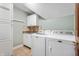 Clean laundry room with modern appliances, tile floor and white cabinets at 325 W Greyhound Pass, Carmel, IN 46032