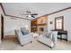 Cozy living room with a brick fireplace, complemented by neutral furniture and ample natural light at 325 W Greyhound Pass, Carmel, IN 46032