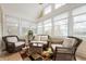 Bright sunroom featuring wicker seating and ample natural light, perfect for relaxing at 325 W Greyhound Pass, Carmel, IN 46032