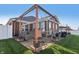 Brick home's backyard patio features pergola, dining, and lounge seating for entertaining at 3254 S Ansley Dr, New Palestine, IN 46163