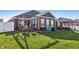 Landscaped backyard patio with furniture and well-maintained lawn, perfect for outdoor enjoyment at 3254 S Ansley Dr, New Palestine, IN 46163