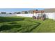 Well-kept backyard with a large lawn, a pergola-covered dining area, and a privacy fence at 3254 S Ansley Dr, New Palestine, IN 46163