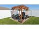 Outdoor dining area with a pergola features comfortable seating for relaxation and entertaining at 3254 S Ansley Dr, New Palestine, IN 46163