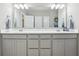 Bathroom featuring double sink vanity with gray cabinets, a large mirror, and modern lighting at 3254 S Ansley Dr, New Palestine, IN 46163