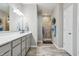 Modern bathroom features a double vanity, gray cabinets, and walk-in tiled shower at 3254 S Ansley Dr, New Palestine, IN 46163
