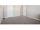 Spacious bedroom features neutral carpet, light gray walls, and two white paneled doors at 3254 S Ansley Dr, New Palestine, IN 46163